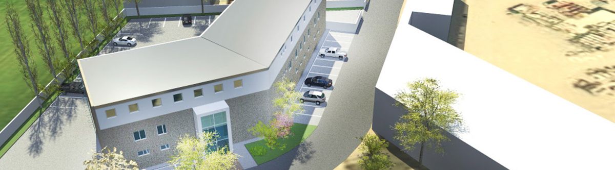 3D-Visualisierung eines Gebäudekomplexes mit Innenhof, Parkplätzen und Grünflächen aus der Vogelperspektive